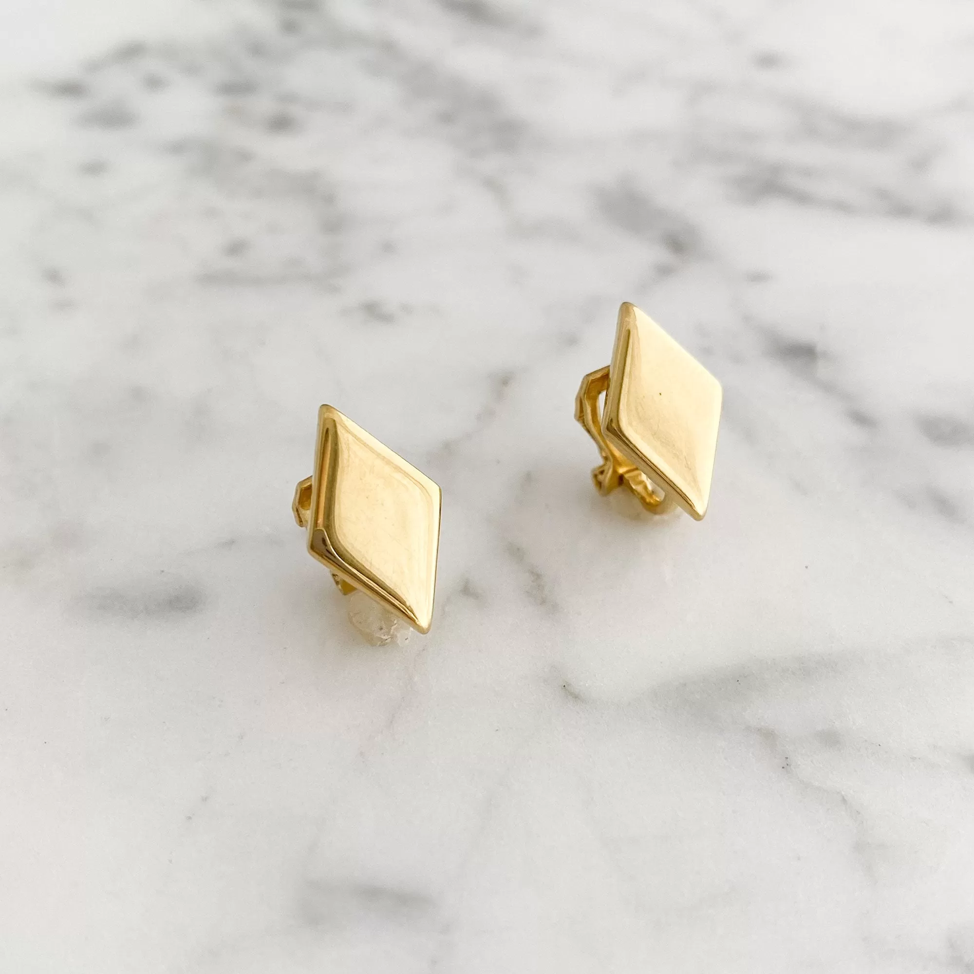 GASTON diamond shaped gold tone clip earrings